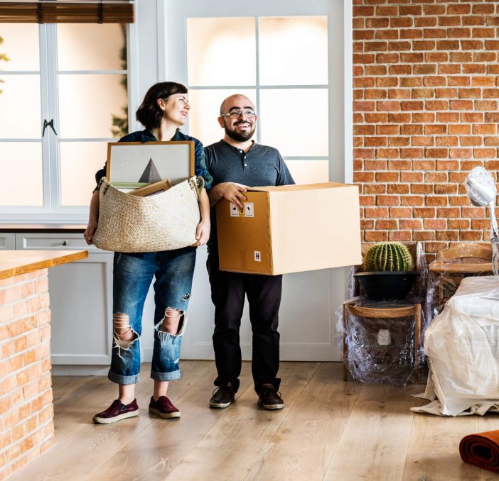 couple moving in a house with boxes