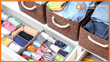 organized drawer with spacers and dividers for clothes, clothing in baskets.
